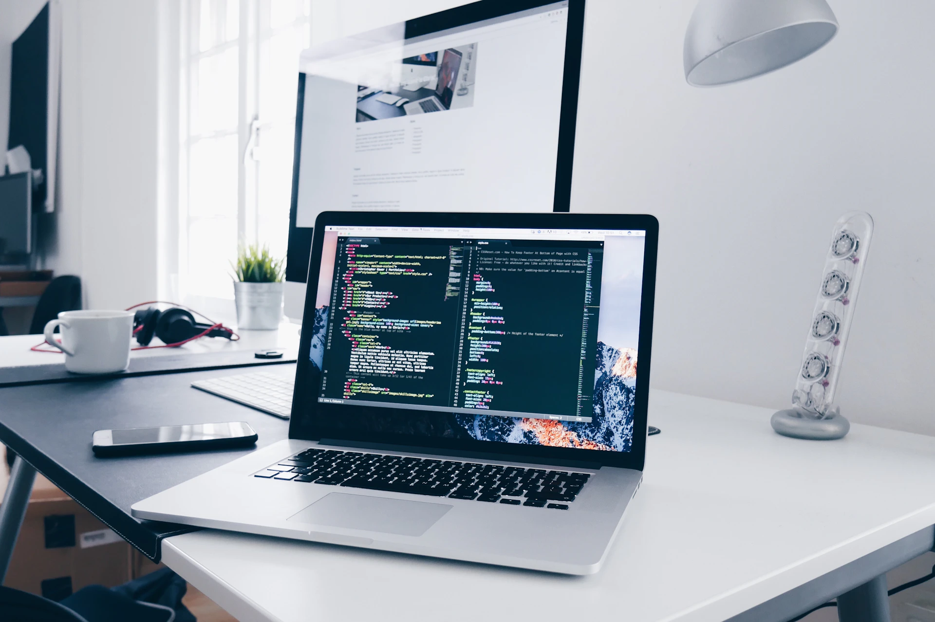 Developer desk with laptop showing code, representing Next.js and React development workflows